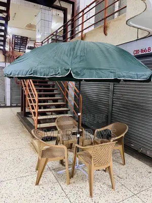 Round Patio Umbrella With a Stand and Four Chairs