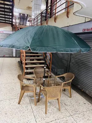 Round Patio Umbrella With a Stand and Four Chairs