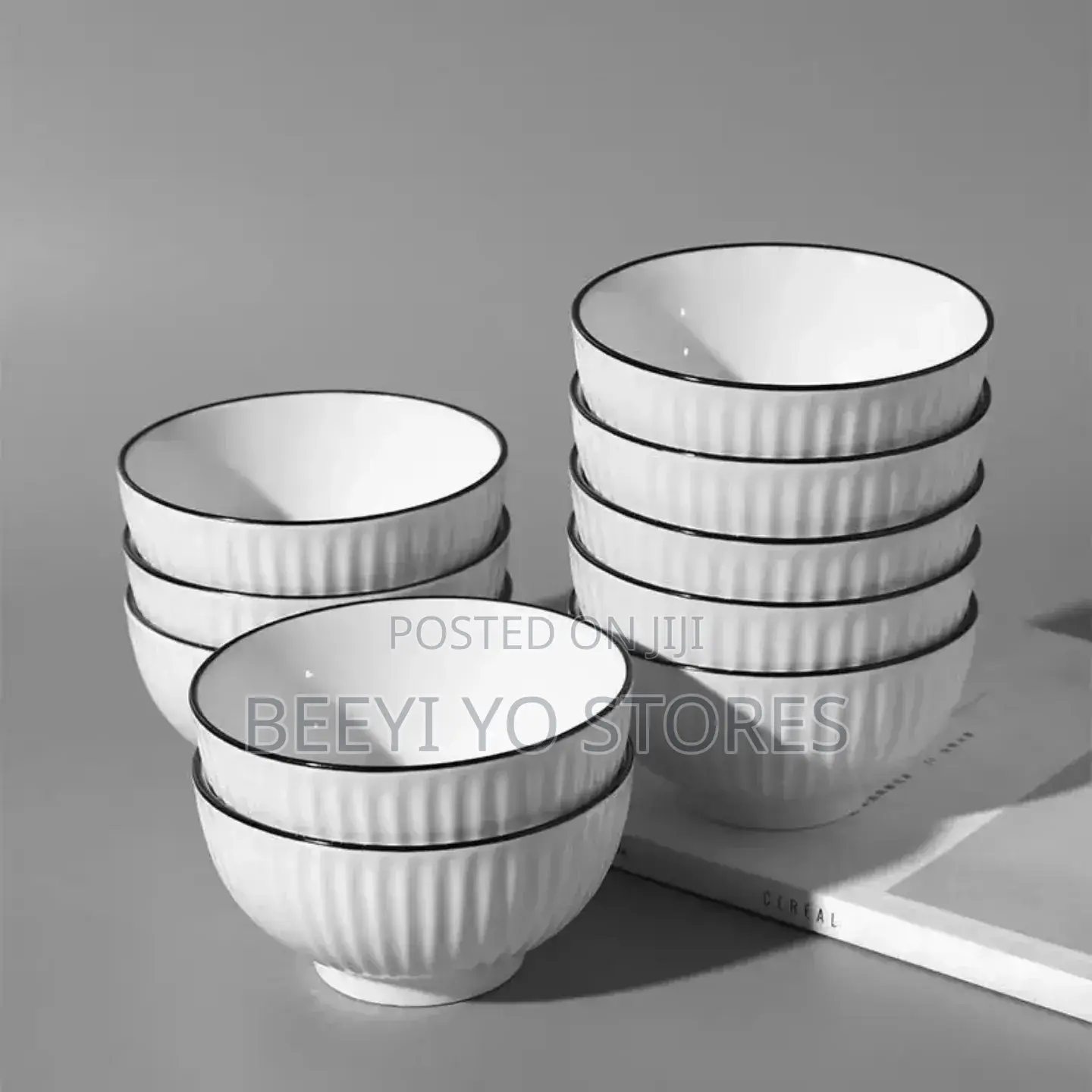 White Ceramic Bowls With Vertical Fluted Ridges and Dark Rims.