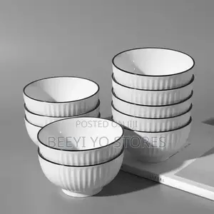 White Ceramic Bowls With Vertical Fluted Ridges and Dark Rims.