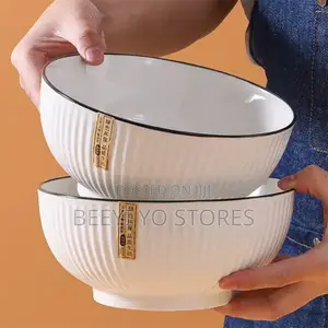 White Ceramic Bowls With Vertical Fluted Ridges and Dark Rims.