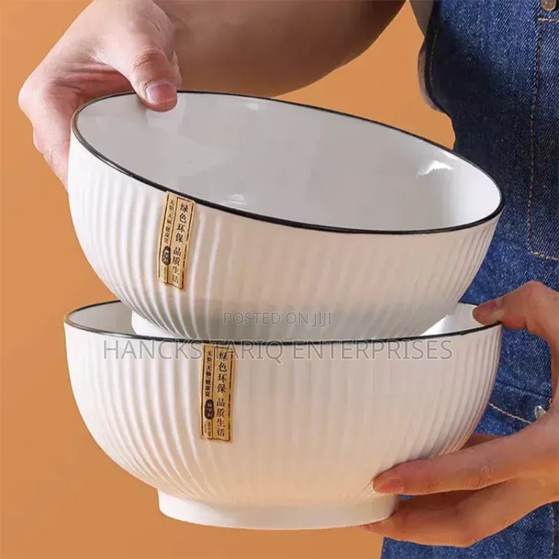 White Ceramic Bowls With Vertical Fluted Ridges and Dark Rims.