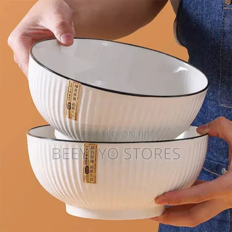 White Ceramic Bowls With Vertical Fluted Ridges and Dark Rims.