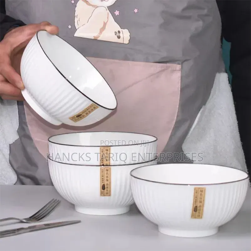 White Ceramic Bowls With Vertical Fluted Ridges and Dark Rims.