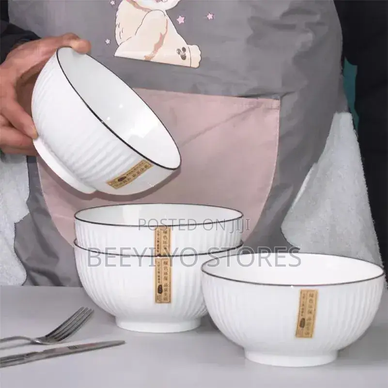 White Ceramic Bowls With Vertical Fluted Ridges and Dark Rims.