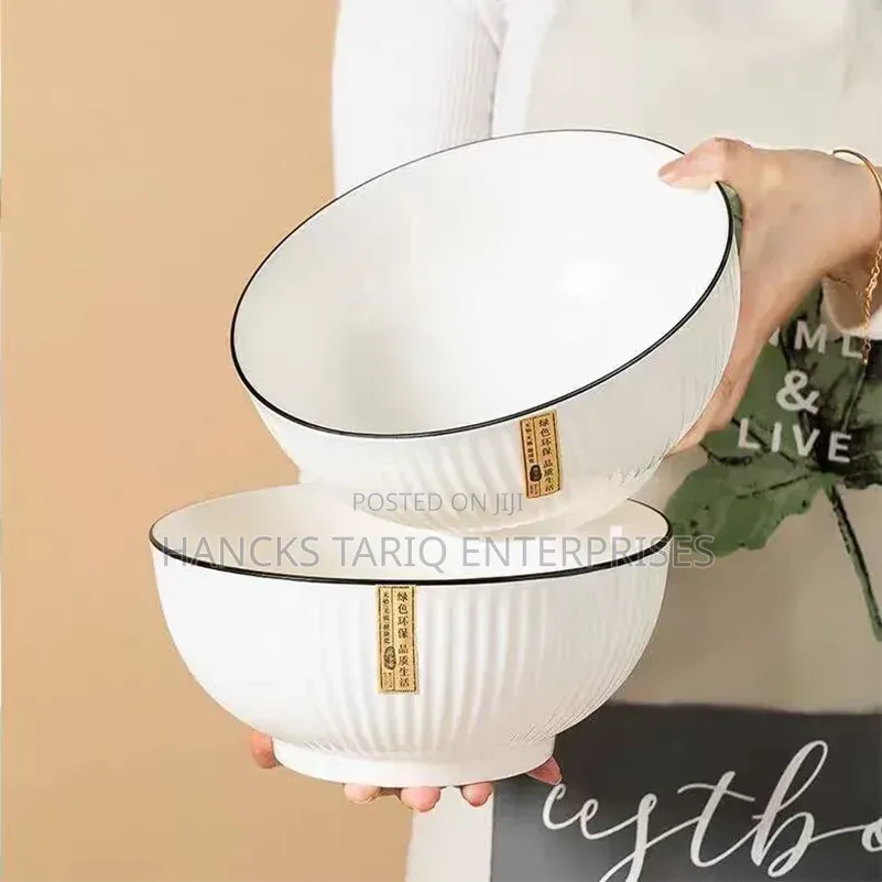 White Ceramic Bowls With Vertical Fluted Ridges and Dark Rims.