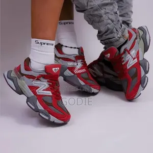 New Balance 9060 Sneakers in a Bold Red and Grey Colorway.