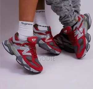 New Balance 9060 Sneakers in a Bold Red and Grey Colorway.