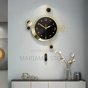Modern Luxury Black and Gold Metal Wall Clock With a Circular Frame.