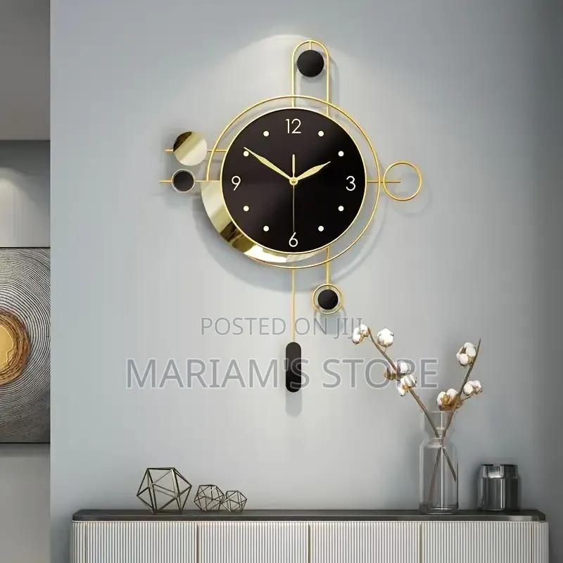 Modern Luxury Black and Gold Metal Wall Clock With a Circular Frame.