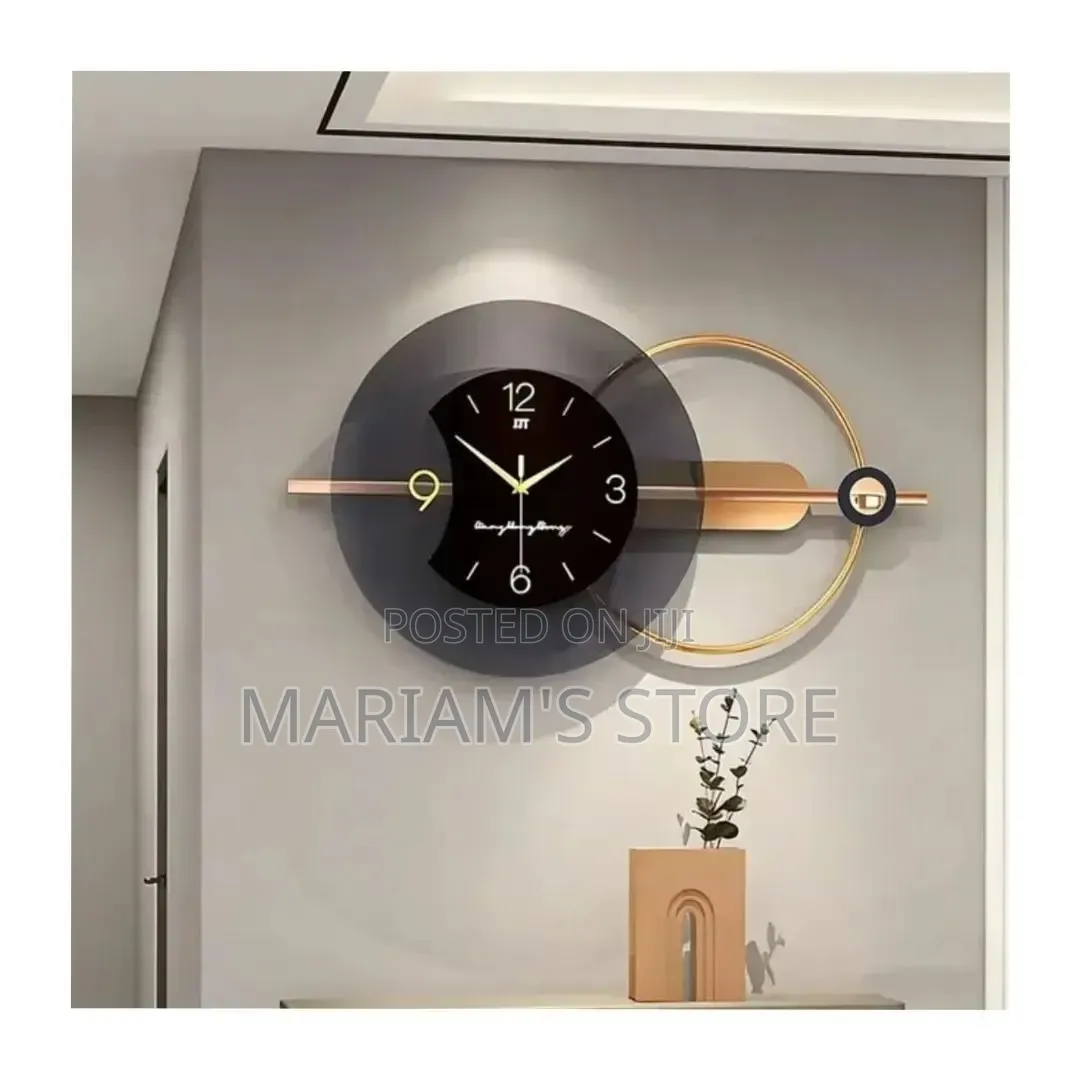 Modern Luxury Black and Gold Metal Wall Clock With a Circular Frame.