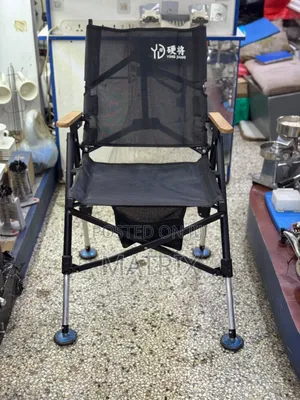 Portable Folding Camping Chair With a Fabric Seat and Wooden Armrests.