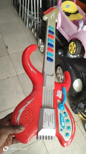 UK Used Red and Gray Plastic Toy Electric Guitar Designed for Children
