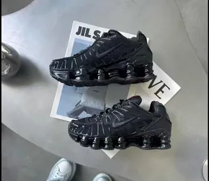 Nike Shox TL Sneakers in a Triple Black Colorway.