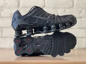 Nike Shox TL Sneakers in a Triple Black Colorway.