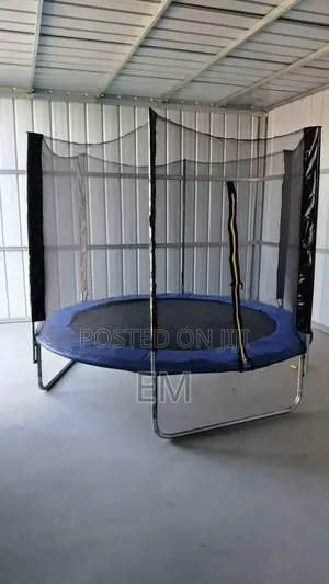A Round Backyard 10 Ft Trampoline With a Safety Enclosure Net