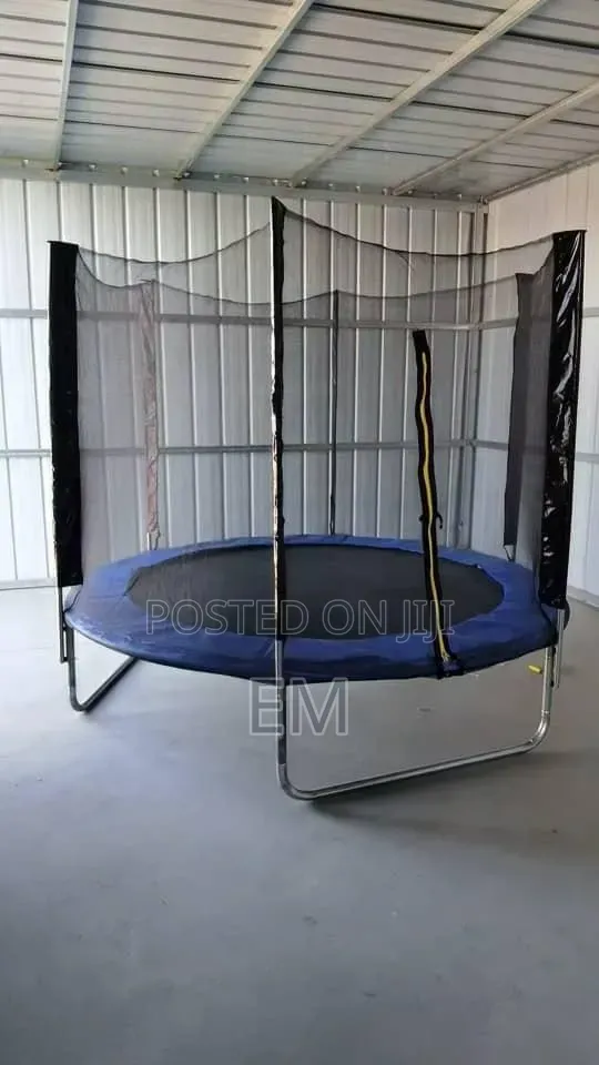 A Round Backyard 10 Ft Trampoline With a Safety Enclosure Net