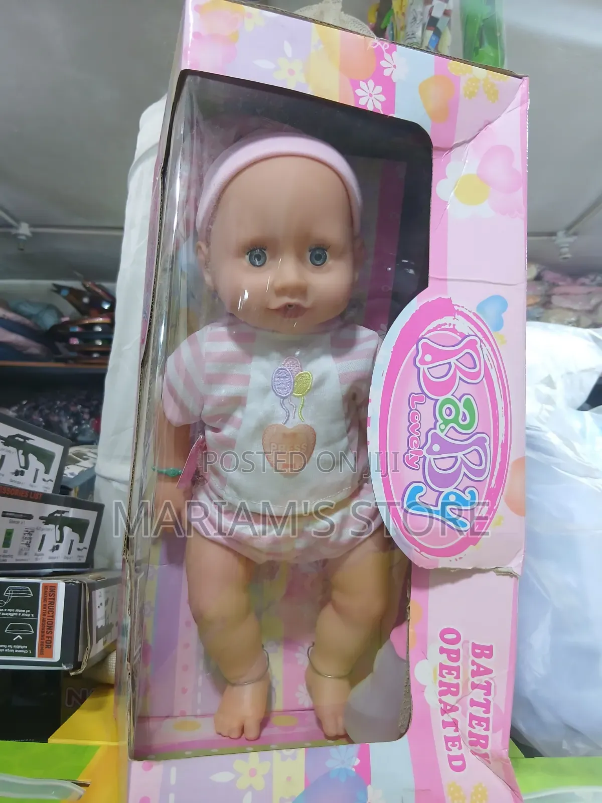 Battery-Operated Baby Doll Packaged in a Pink and Floral Window Box.