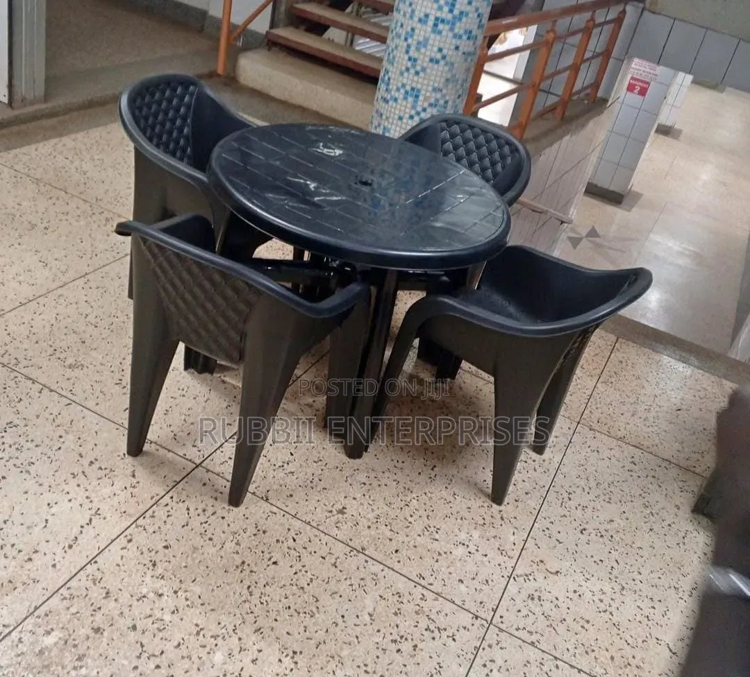 1 Round Table + 4 Molded Plastic Arm Chair