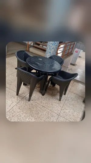1 Round Table + 4 Molded Plastic Arm Chair