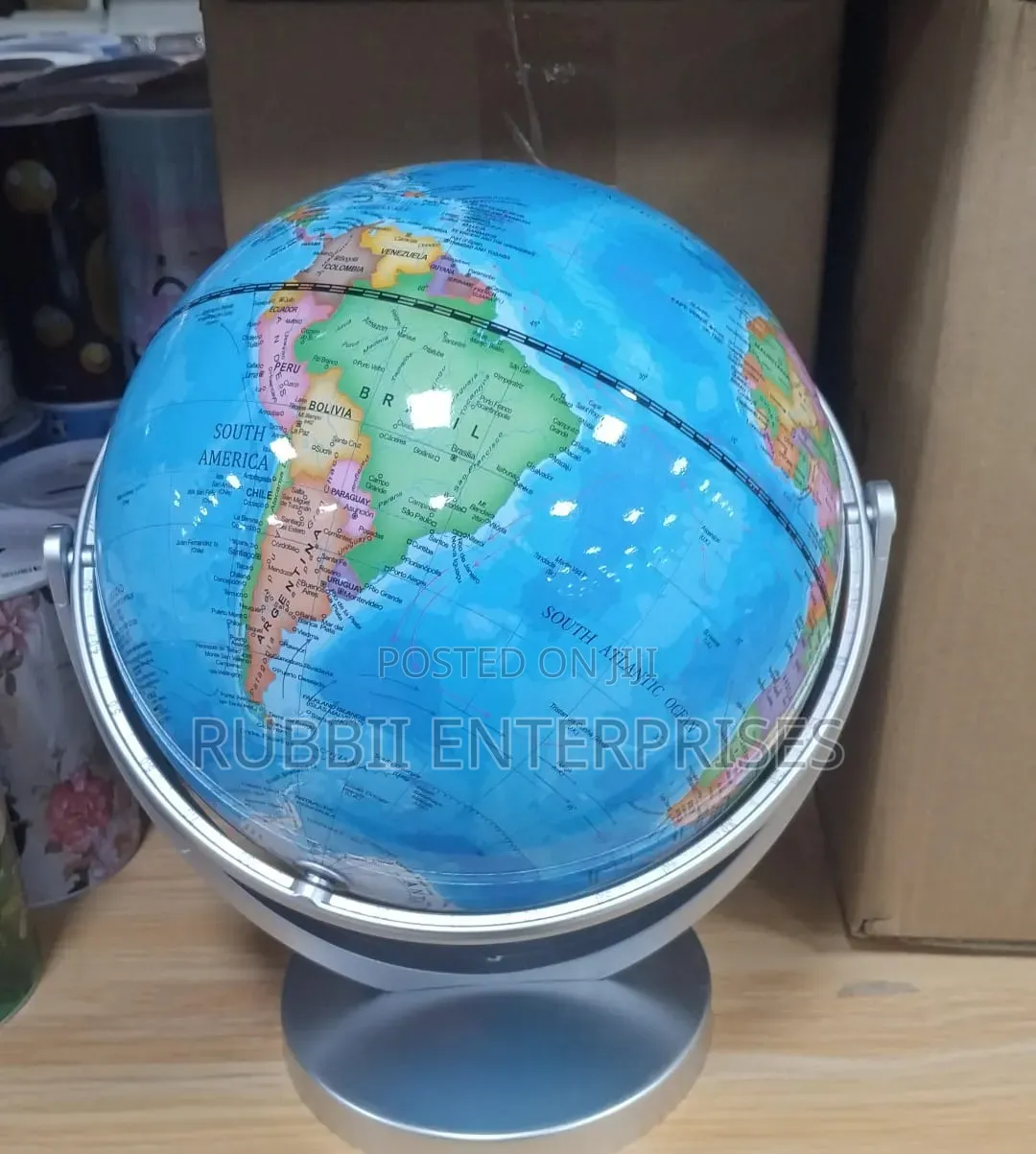 World Globe on a Rotating Silver Metal Swivel Stand.