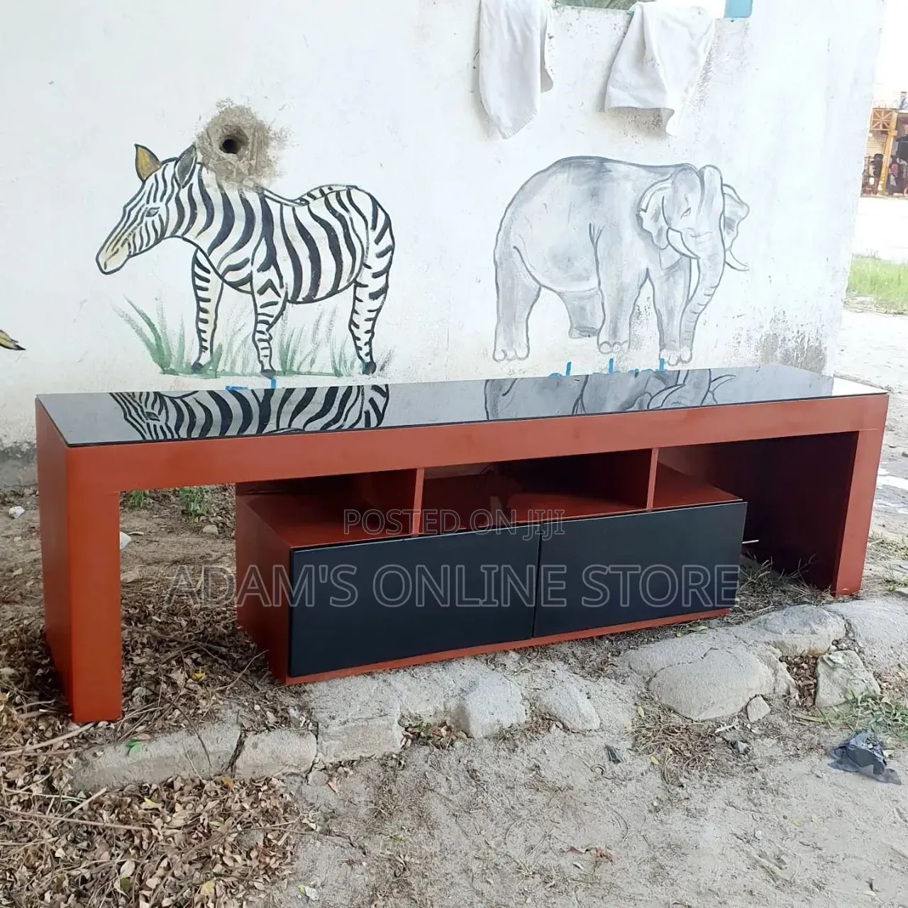 Brown TV Stand Unit With Black Glass on Top