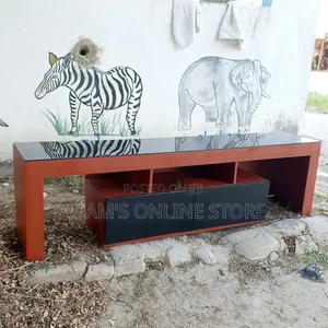 Brown TV Stand Unit With Black Glass on Top
