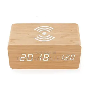 Wooden Digital Alarm Clock With Built-in Wireless Charging Pad on Top.