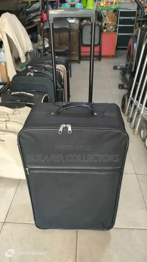 Japanese Black, Soft-Sided Rolling Suitcase With a Telescopic Handle.