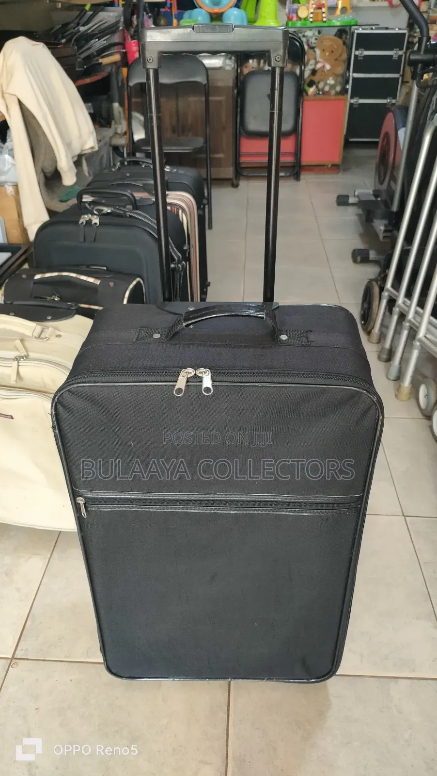 Japanese Black, Soft-Sided Rolling Suitcase With a Telescopic Handle.