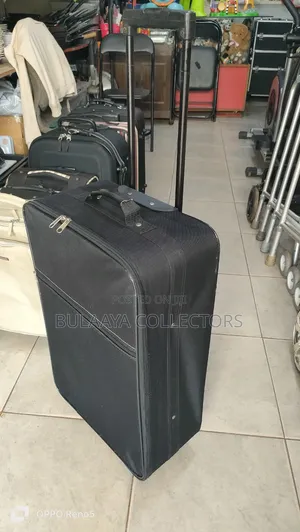 Japanese Black, Soft-Sided Rolling Suitcase With a Telescopic Handle.