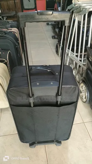 Japanese Black, Soft-Sided Rolling Suitcase With a Telescopic Handle.
