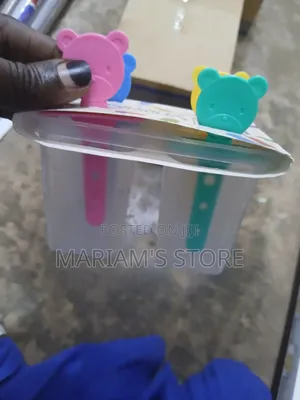 Popsicle Maker With Colorful Reusable Handles and a Clear Mold Base.