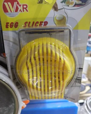 Yellow and Silver Manual Egg Slicer With a Slotted Plastic Base