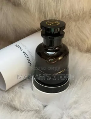 Dark Glass Bottle and Cylindrical White Box of Louis Vuitton Perfume
