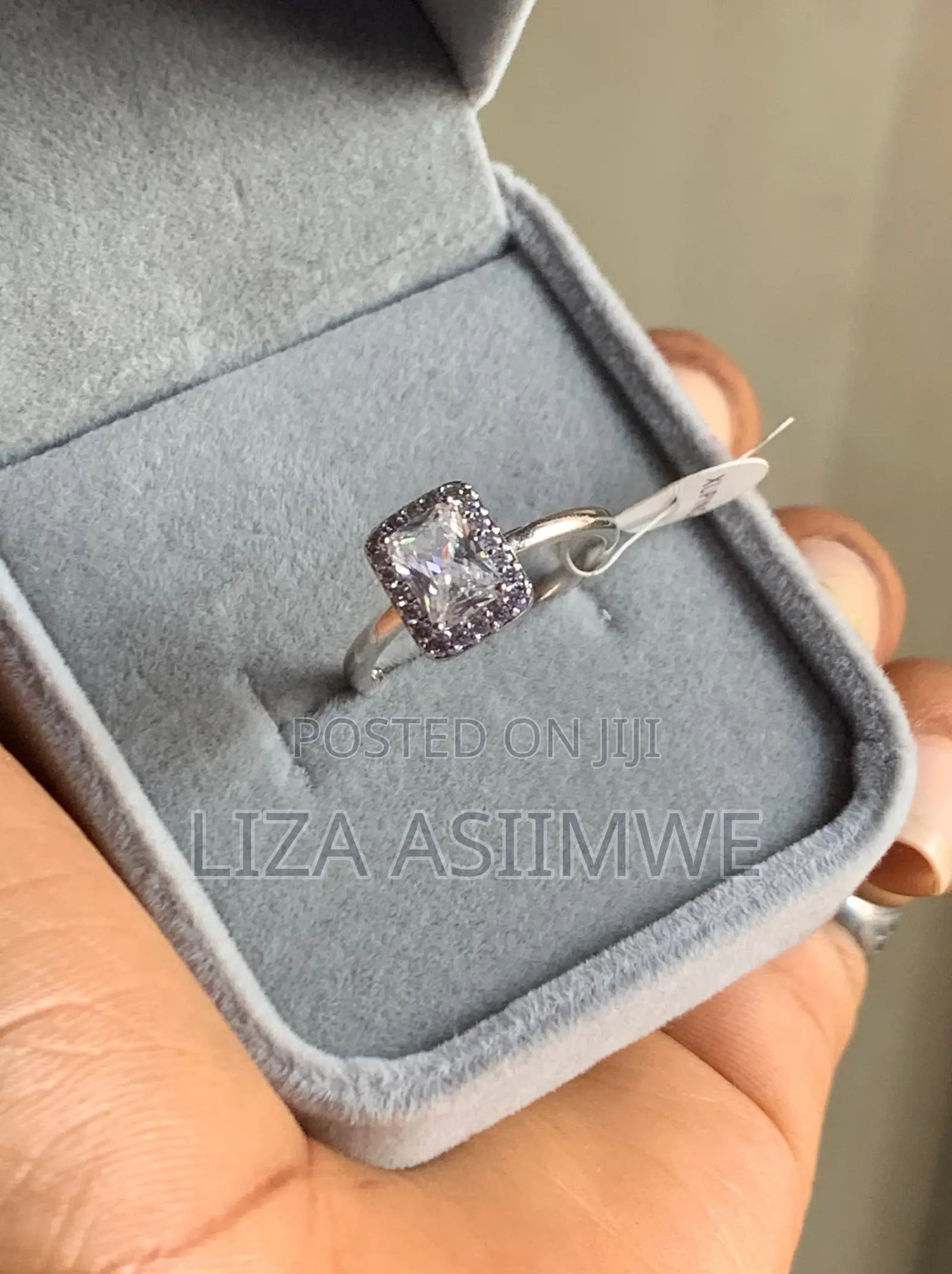 Rectangular Sparkling Halo Ring Featuring a Radiant-Cut Center Stone