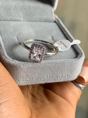 Rectangular Sparkling Halo Ring Featuring a Radiant-Cut Center Stone