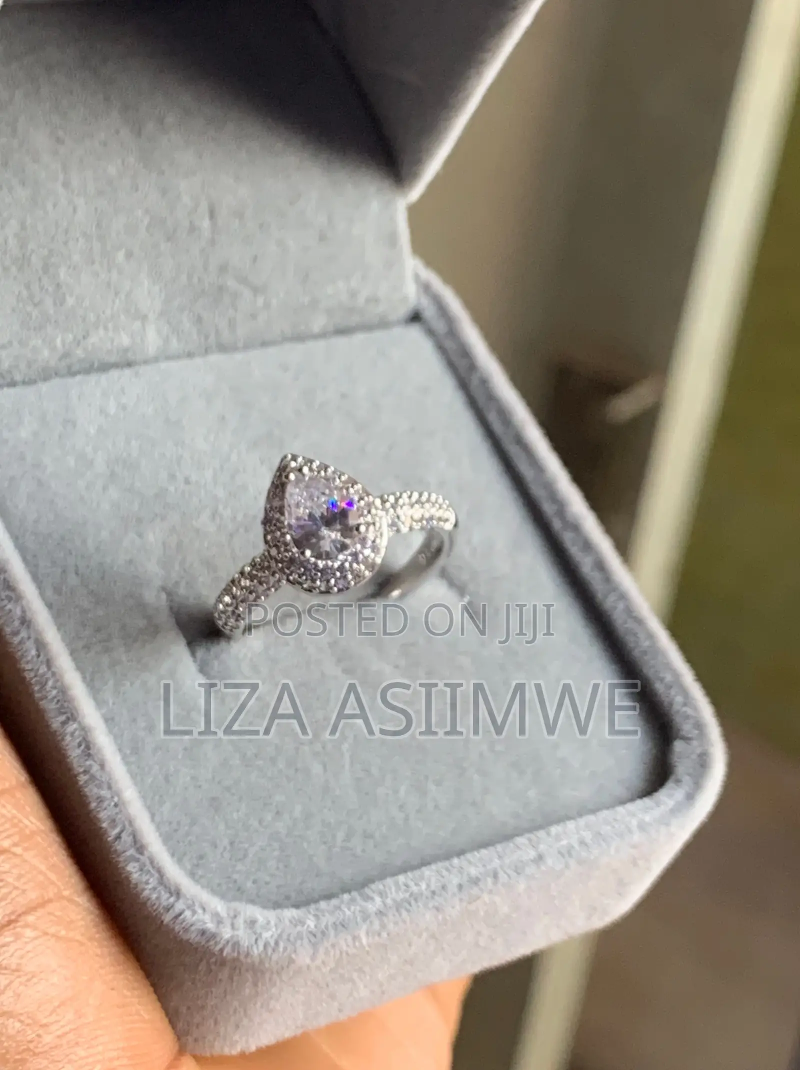 Elegant Engagement Ring Features a Pear-Shaped Center Stone Frame