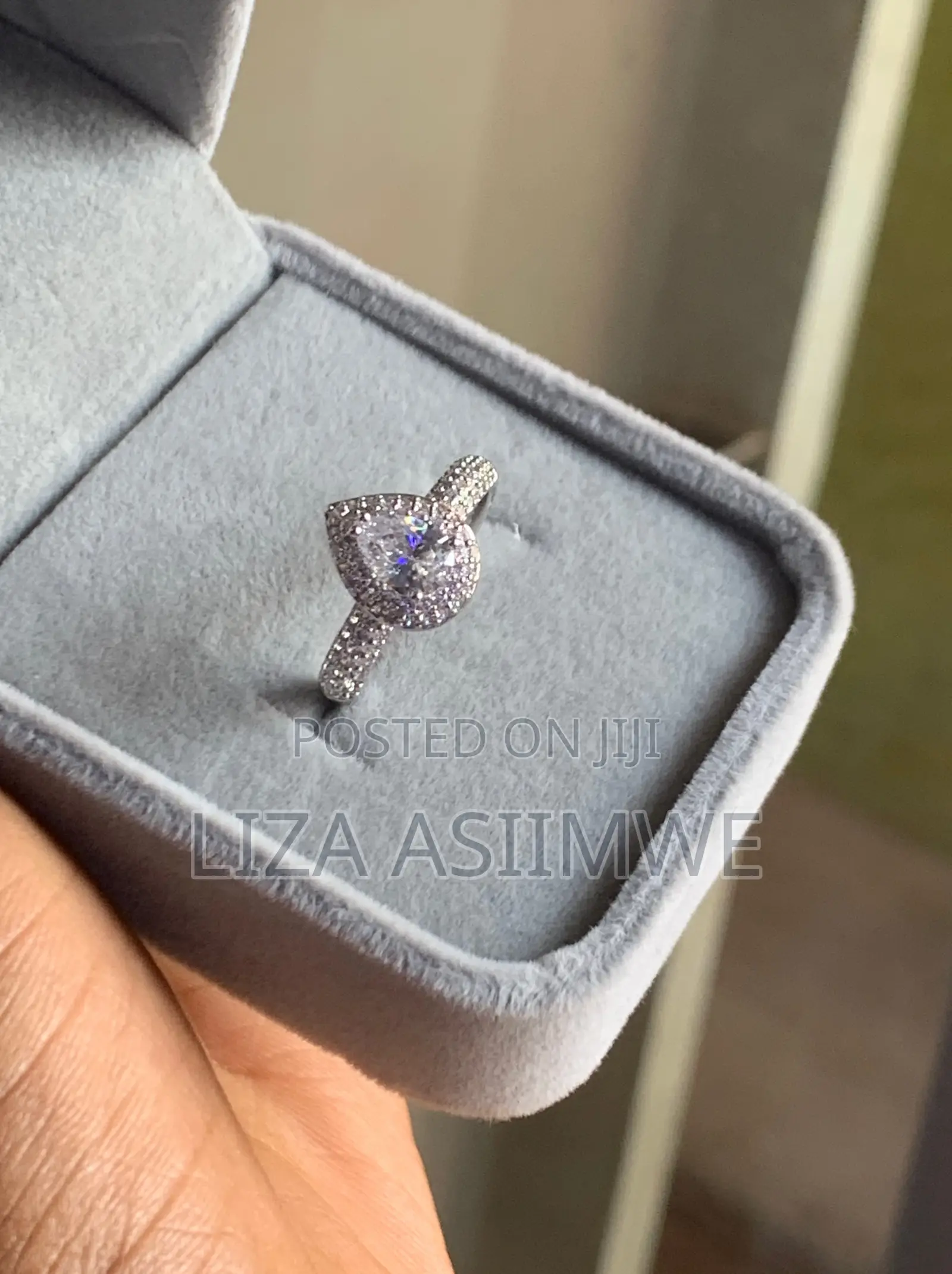 Elegant Engagement Ring Features a Pear-Shaped Center Stone Frame