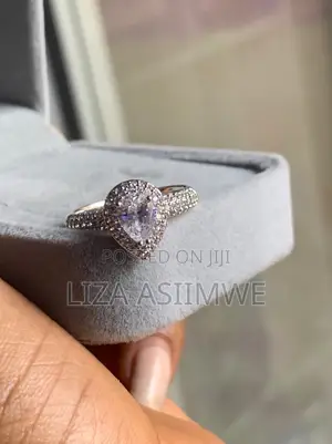 Elegant Engagement Ring Features a Pear-Shaped Center Stone Frame
