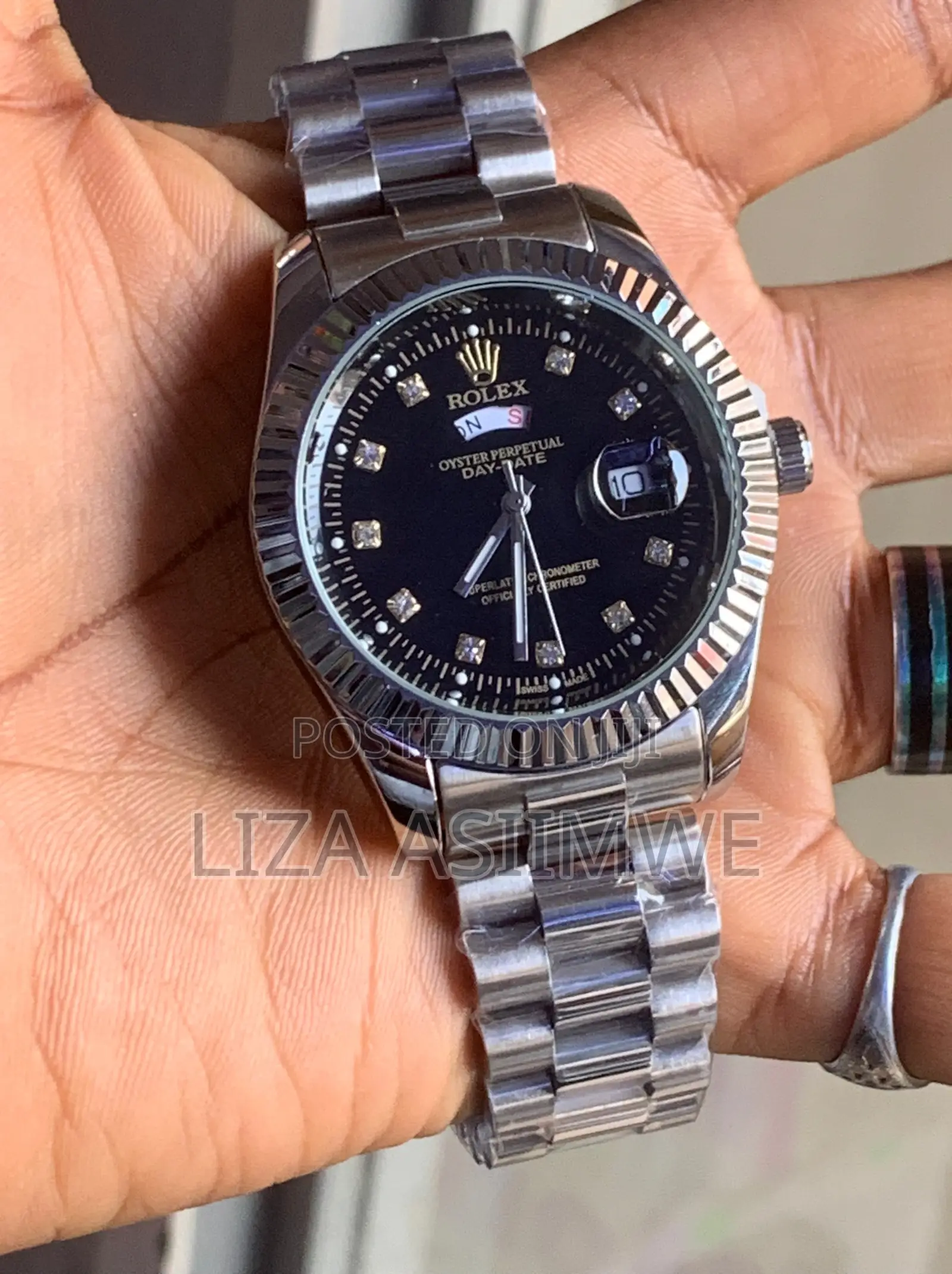 Silver Metal Rolex Watch With a Black Dial With Crystal Hour Markers