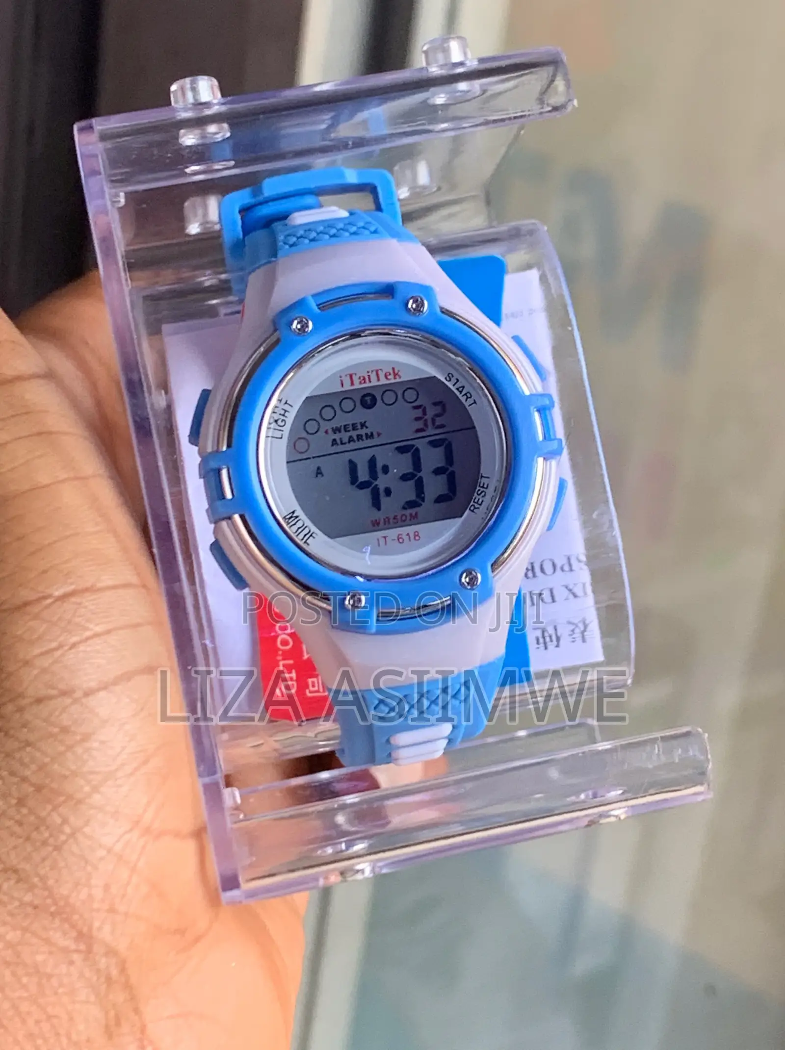 Children's Digital Sports Watch With a Blue and White Plastic Strap
