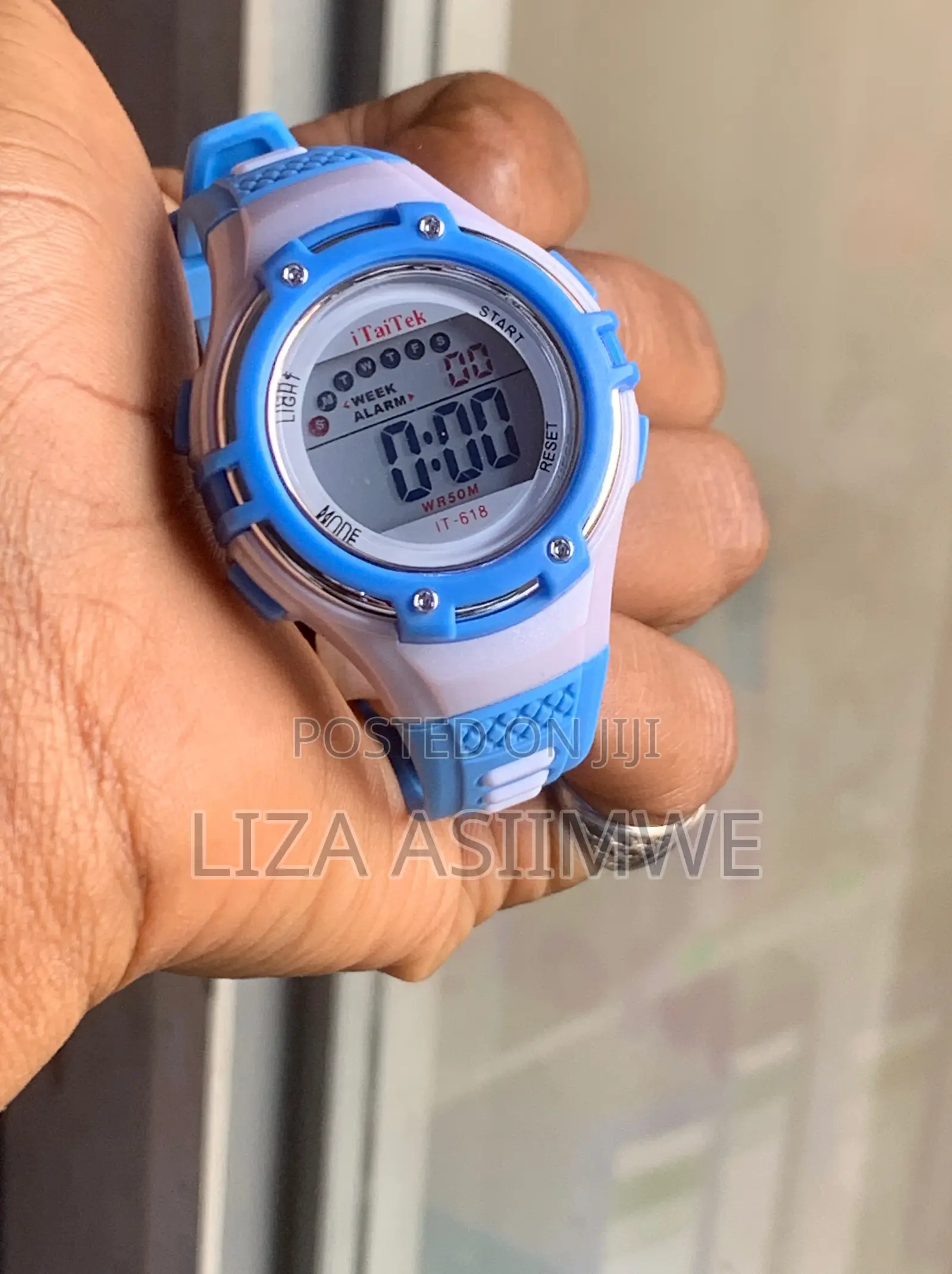 Children's Digital Sports Watch With a Blue and White Plastic Strap