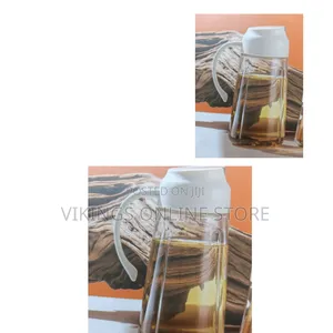 An Auto Flip Olive Oil and Vinegar Dispenser Glass Oil Bottle
