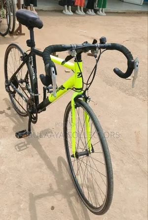 UK Black and Neon-Green Trinx Tempo Road Bike With Drop Handlebars.