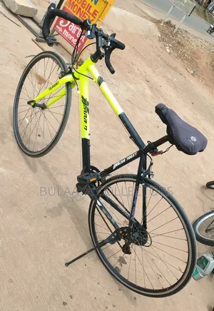 UK Black and Neon-Green Trinx Tempo Road Bike With Drop Handlebars.