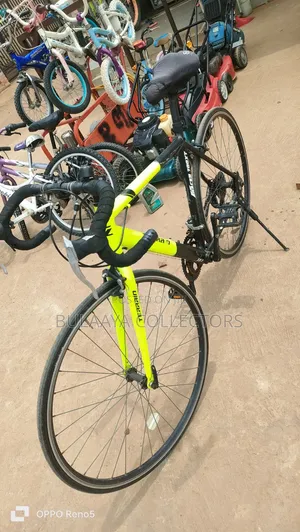 UK Black and Neon-Green Trinx Tempo Road Bike With Drop Handlebars.