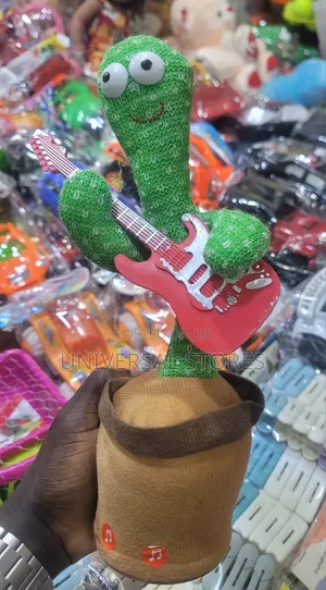 Electric Dancing and Singing Cactus Toy Holding a Red Toy Guitar.
