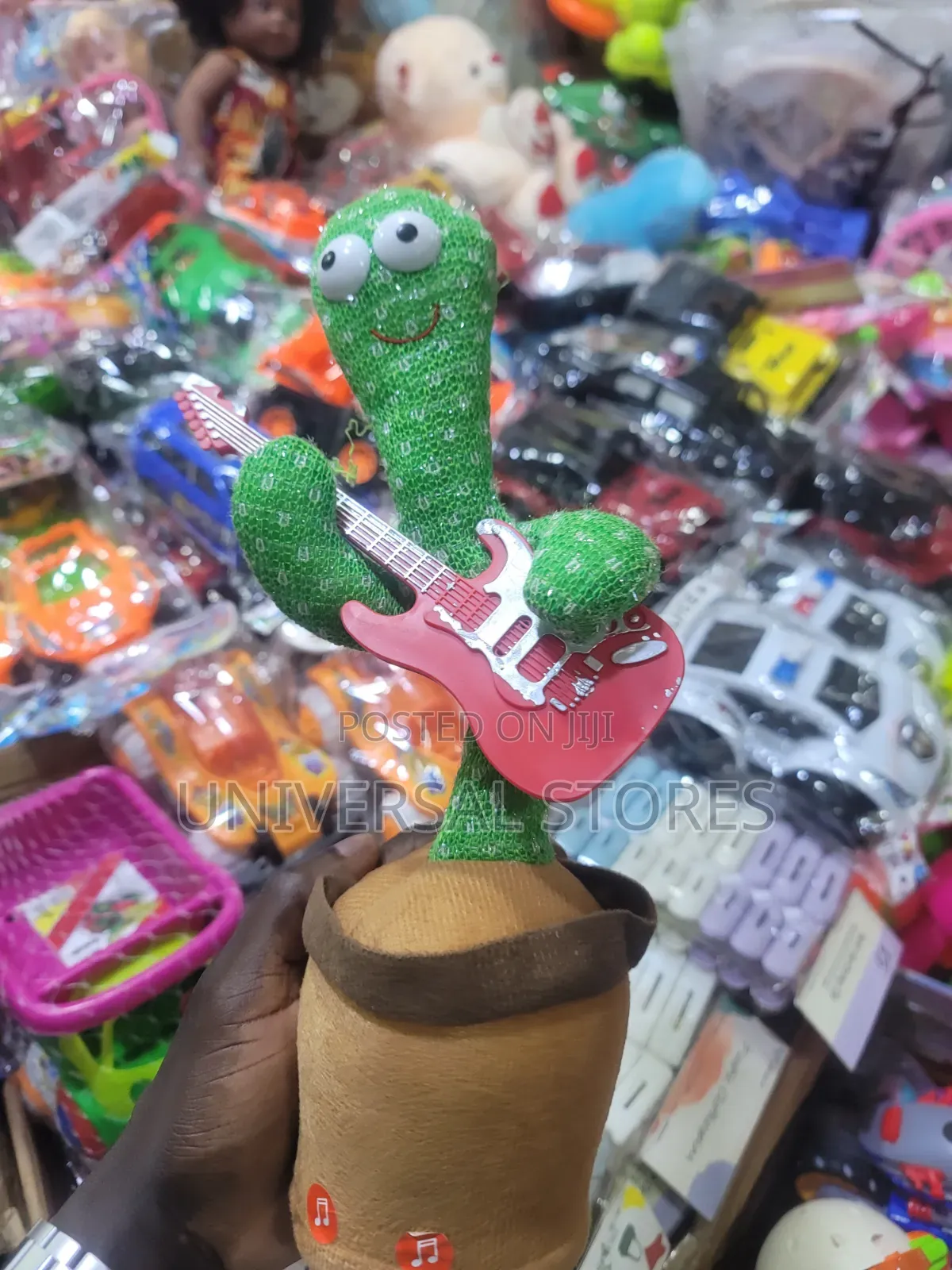 Electric Dancing and Singing Cactus Toy Holding a Red Toy Guitar.