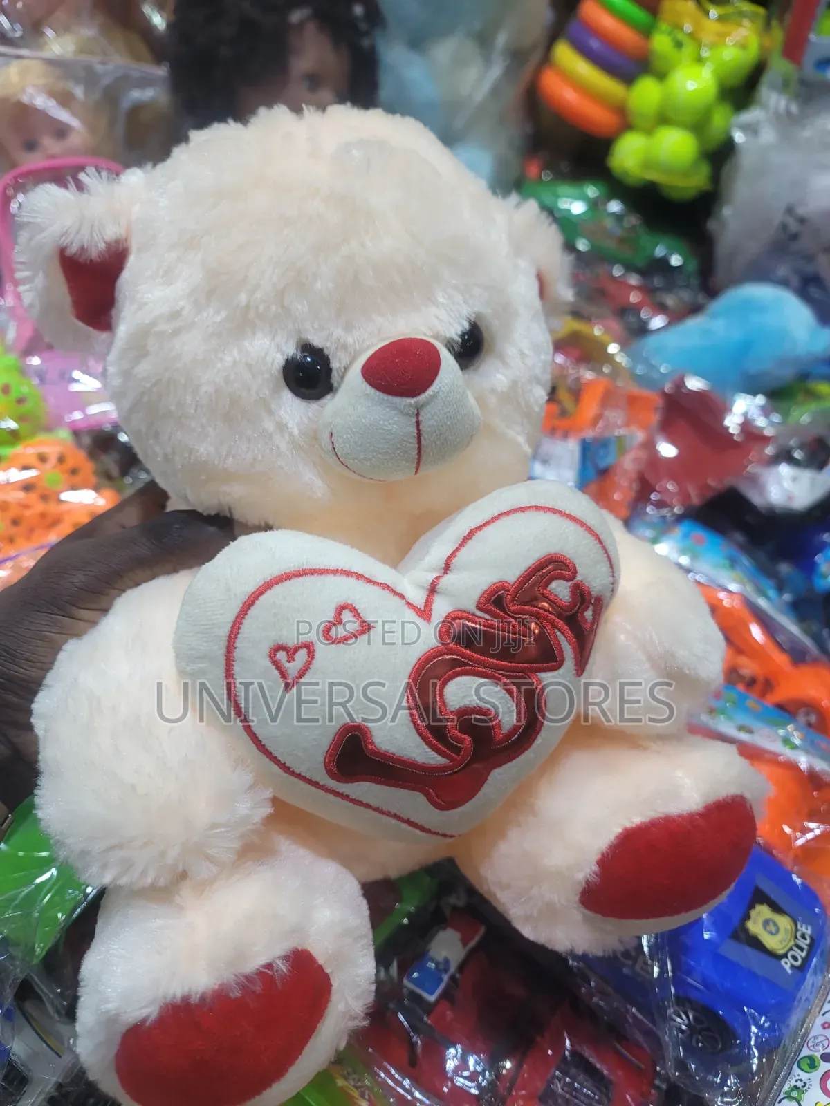 Cream-Colored Plush Teddy Bear Holding a White Heart Pillow